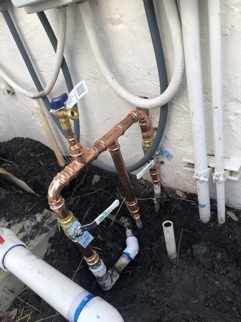 New copper water line with shutoff valves plumbed on the outside wall of a home
